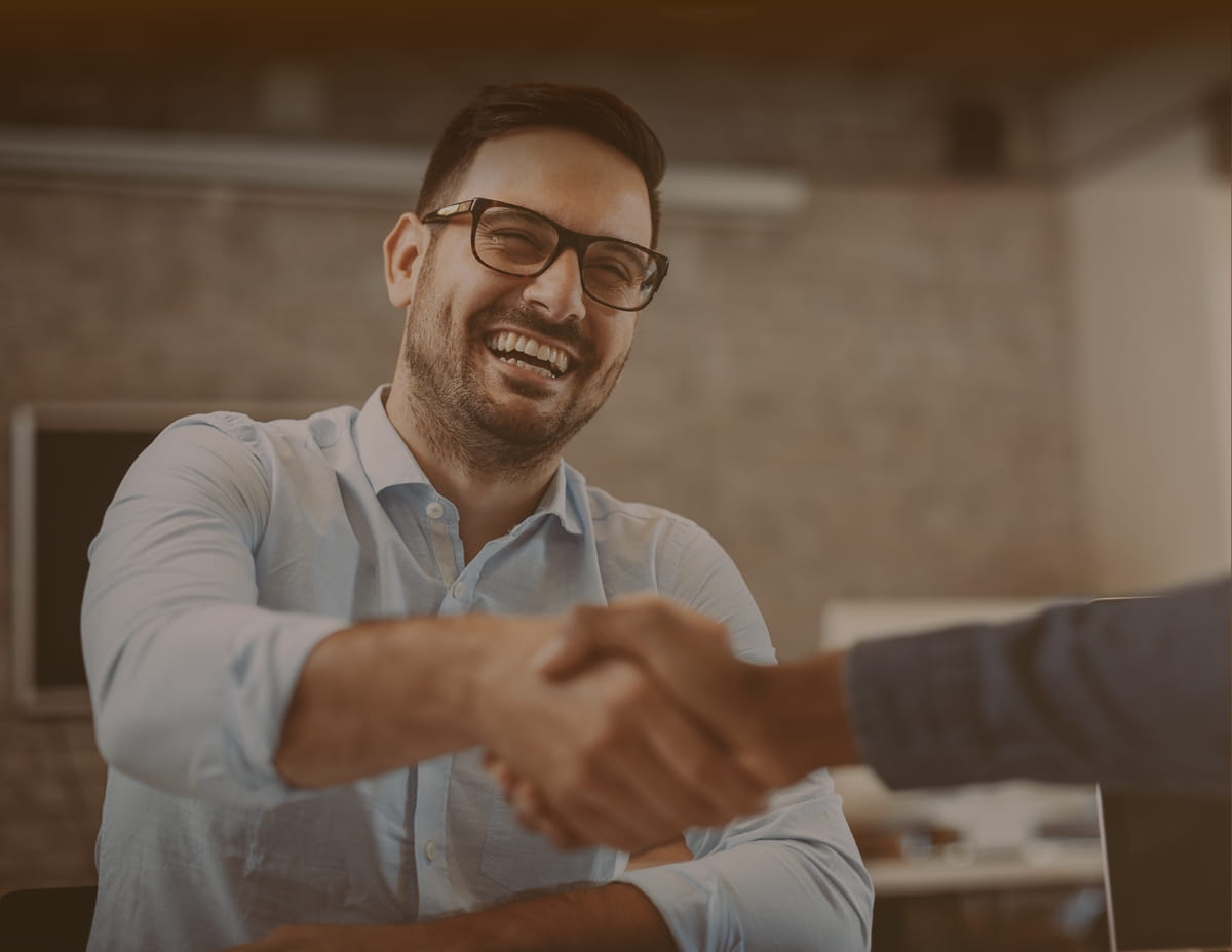 man shaking hands with another person
